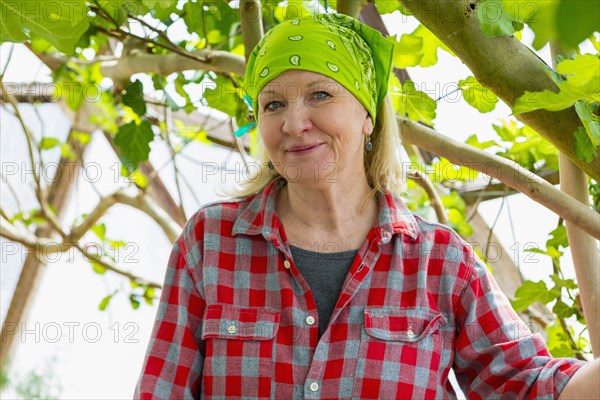 Caucasian woman posing in greenhouse