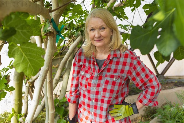 Caucasian woman posing in greenhouse