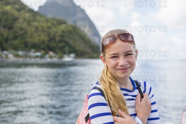 Smiling Caucasian girl near ocean