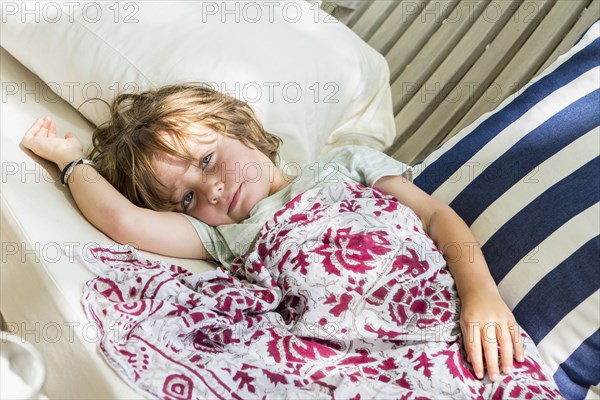 Caucasian boy laying on chair