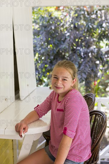 Portrait of smiling Caucasian girl sitting outdoors