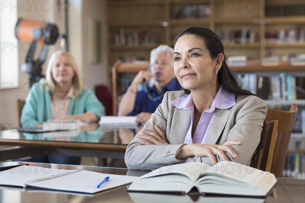 Curious older woman listening in library