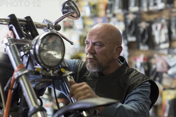 Caucasian man repairing motorcycle