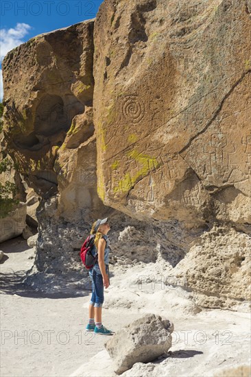 Caucasian girl admiring rocks while hiking