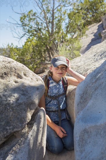 Portrait of Caucasian girl leaning on rock