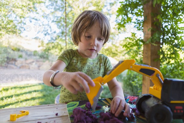 Caucasian boy playing with construction toy