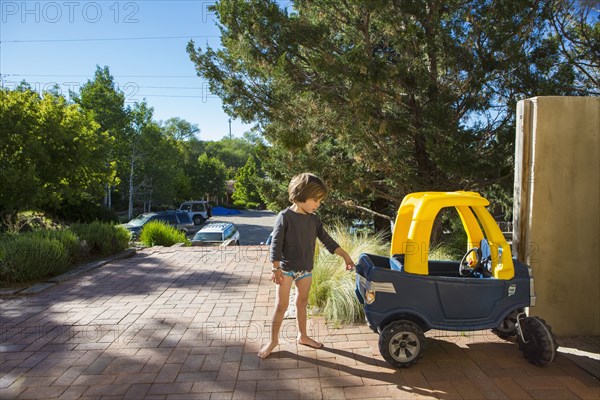 Caucasian boy playing with toy car