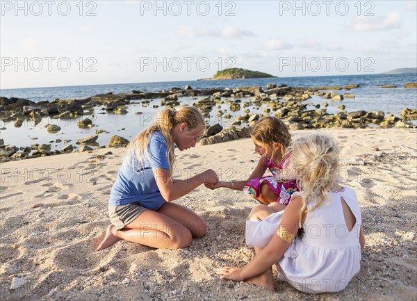Caucasian girls playing at beach