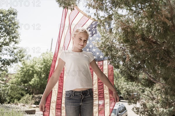 Caucasian girl posing with American flag