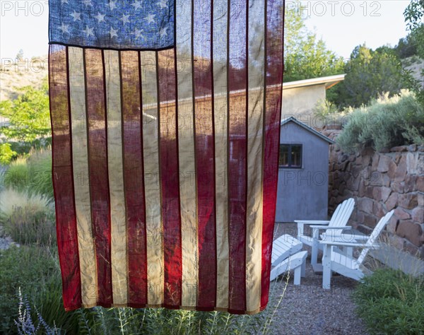 American flag hanging near house