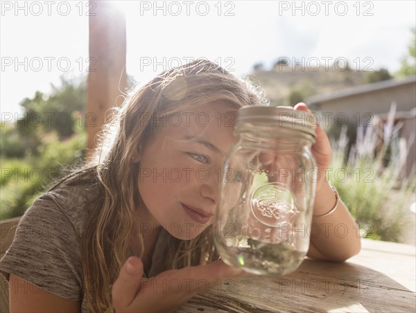 Caucasian girl looking at jar