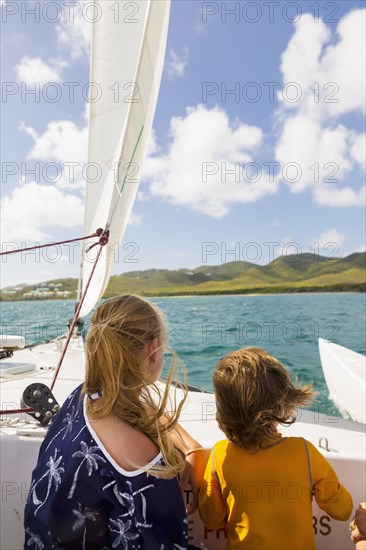 Caucasian brother and sister on sailboat