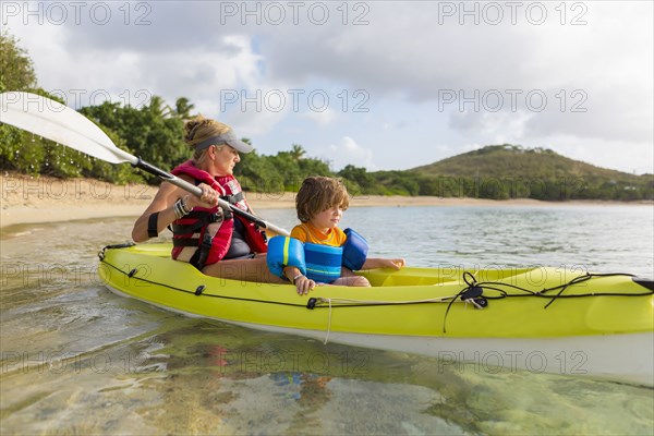 Caucasian mother and son in kayak
