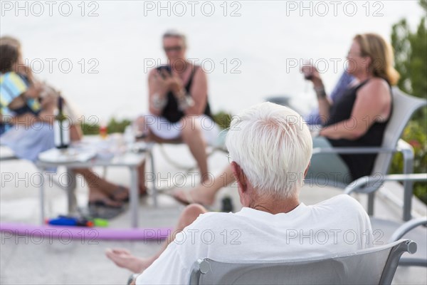 Caucasian people relaxing on patio