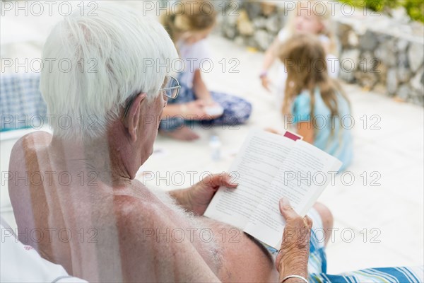 Caucasian man reading book in summer