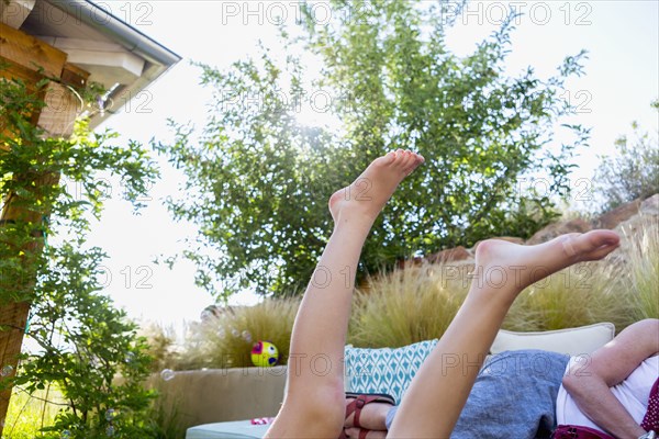 Legs of Caucasian girl in backyard