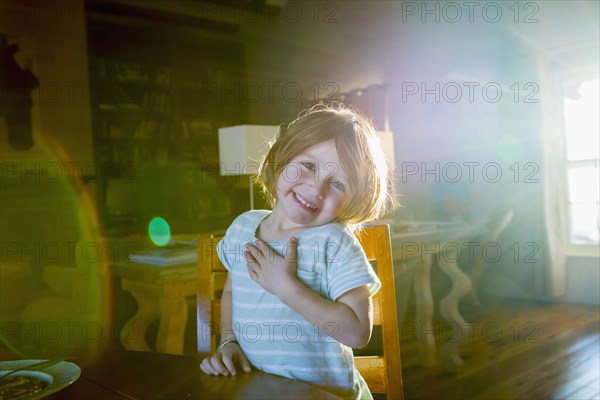 Sunshine on Caucasian boy sitting at table