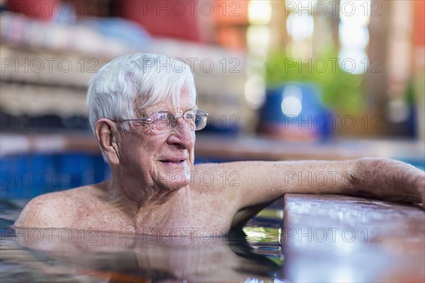 Pensive Caucasian man in swimming pool