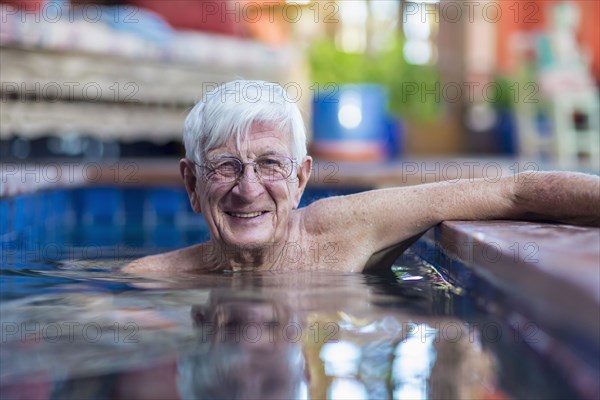 Smiling Caucasian man in swimming pool