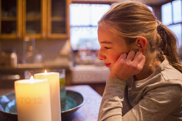 Smiling and Caucasian girl watching candles