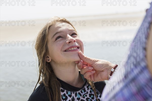 Caucasian mother admiring face of daughter