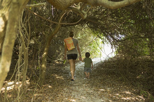 Caucasian mother and son walking on path