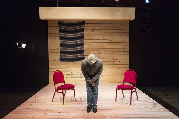 Hispanic man bowing on theater stage