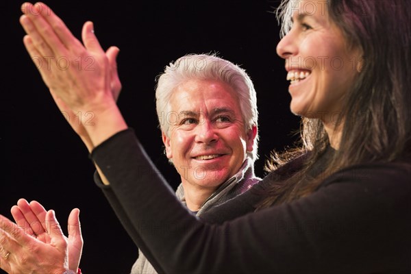 Hispanic man and woman clapping hands