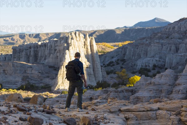 Caucasian man carrying backpack in desert