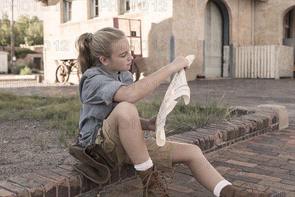 Caucasian girl reading map