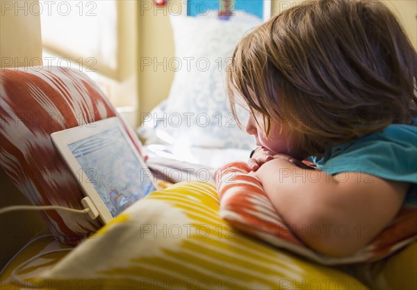 Caucasian boy watching digital tablet