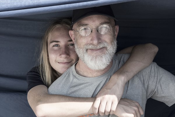 Caucasian boy hugging father