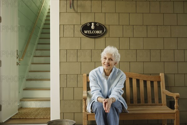 Senior woman smiling on the porch