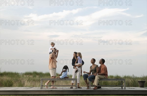 Families playing on wooden benches