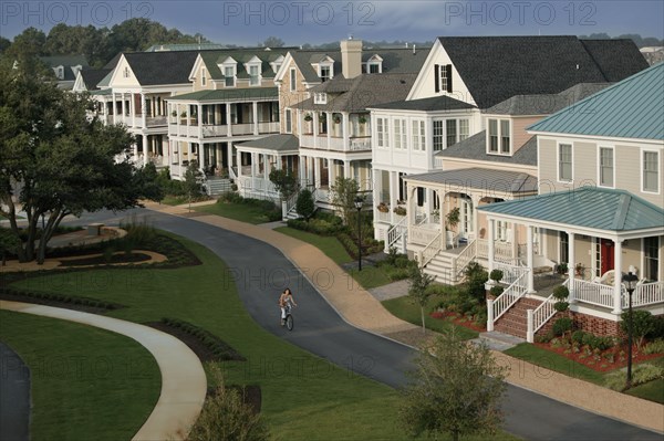 Woman riding a bike down suburban street