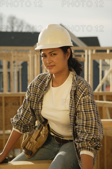 Asian female construction worker at construction site