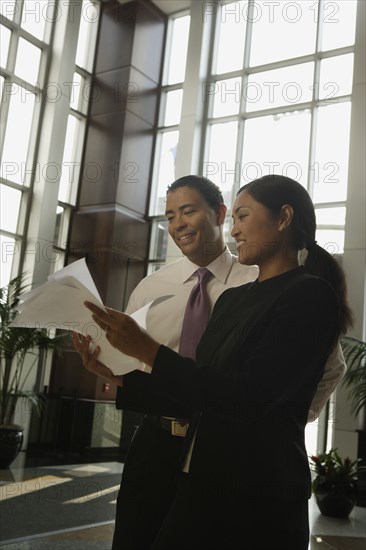 Multi-ethnic businesspeople looking at paperwork