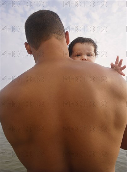 Mixed Race father holding baby