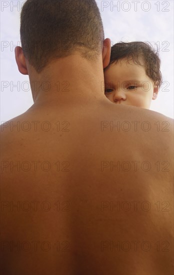 Mixed Race father holding baby