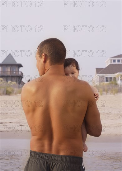 Mixed Race father holding baby