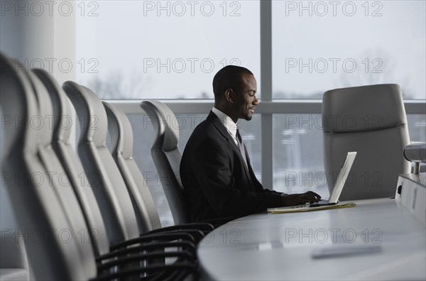 African American businessman typing on laptop