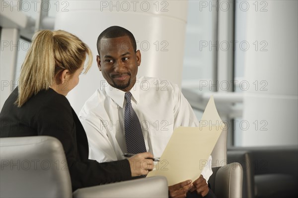 Multi-ethnic businesspeople discussing paperwork