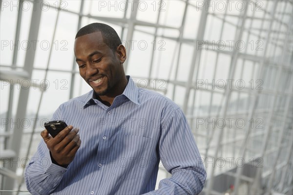 African American businessman looking at cell phone
