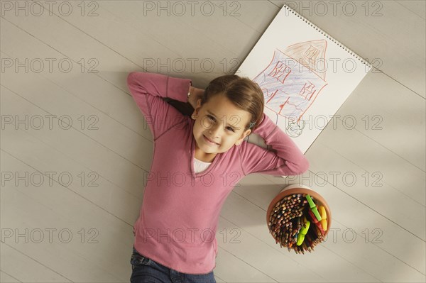 Mixed Race girl next to drawing