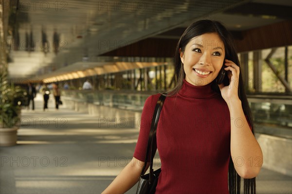 Asian woman talking on cell phone