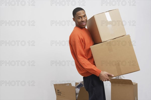 African man carrying moving boxes