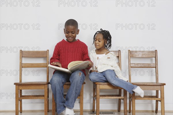 African boy reading to sister