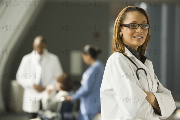 African doctor with arms crossed looking pensive