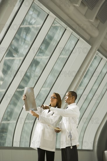 African doctors reviewing x-rays by window