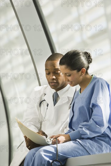 Doctor and nurse reviewing medical chart